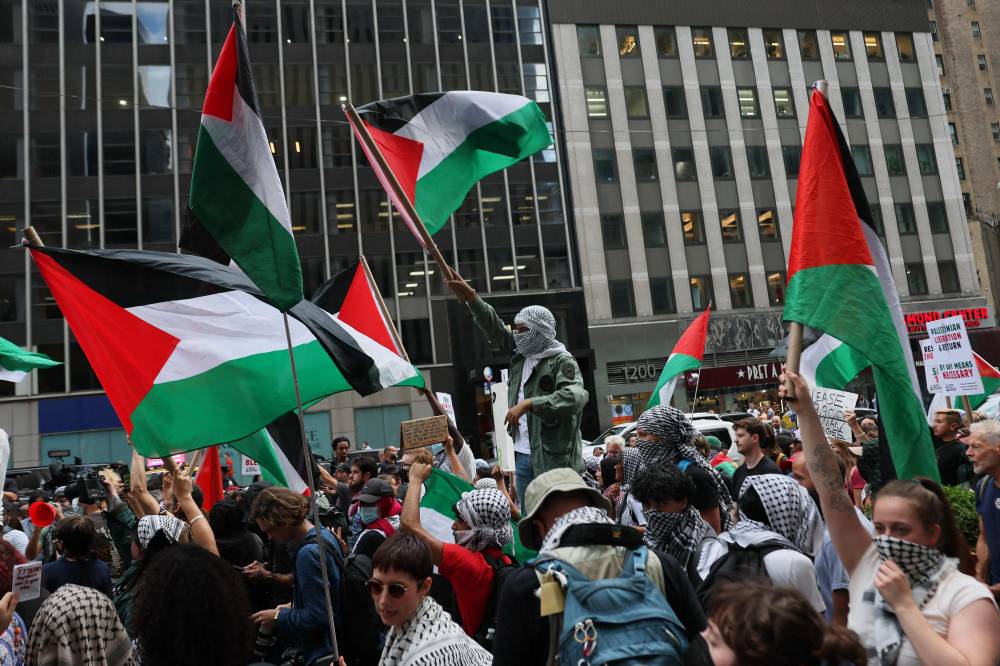 Pro-Palestinian activists protest the war in Gaza on the October 7th Anniversary at the Newscorp headquarters on October 07, 2025 in New York City. (Photo by Michael M. Santiago / GETTY IMAGES NORTH AMERICA / Getty Images via AFP)