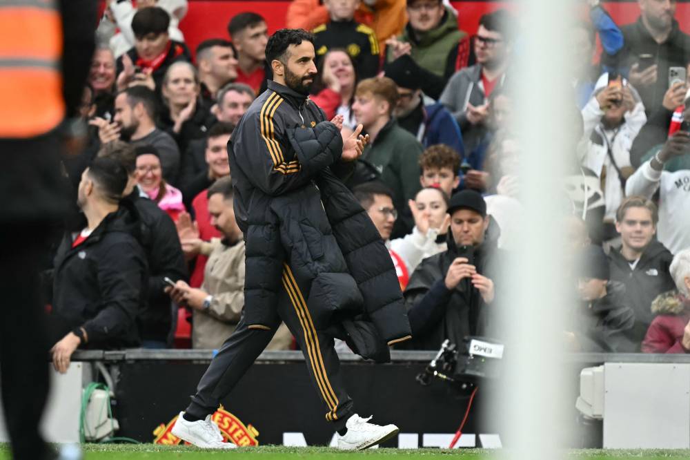 Manchester United's Portuguese head coach Ruben Amorim applauds as he leaves after the English Premier League football match between Manchester United and Sunderland at Old Trafford in Manchester, north west England, on October 4, 2025. United won the game 2-0. (Photo by Paul ELLIS / AFP)