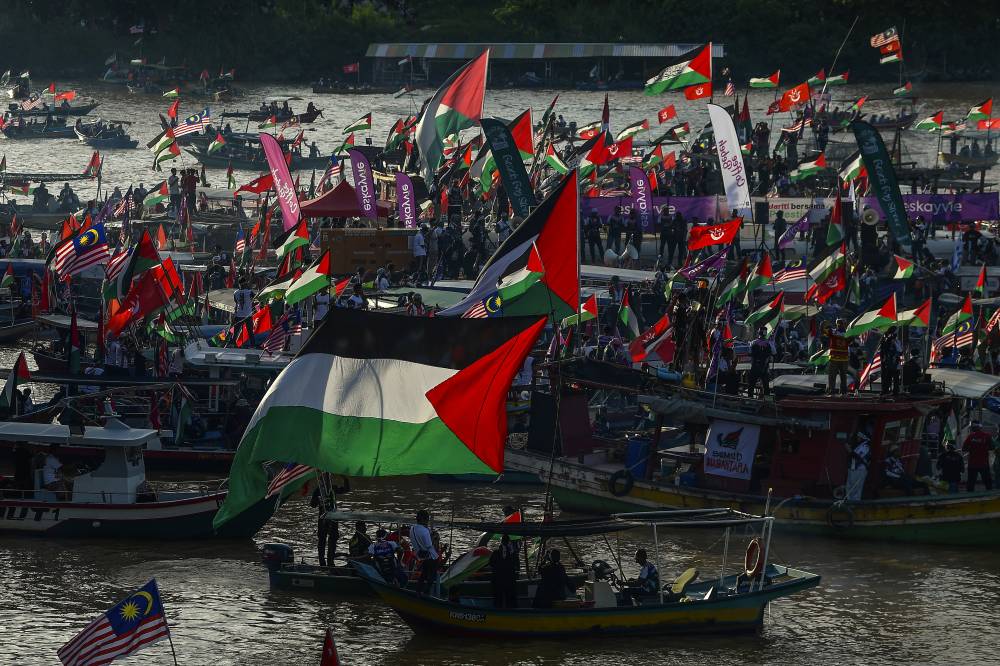 Around 1,000 fishing and private boats sailed along Sungai Kelantan for eight kilometres on Friday in a show of solidarity with Palestine through the 