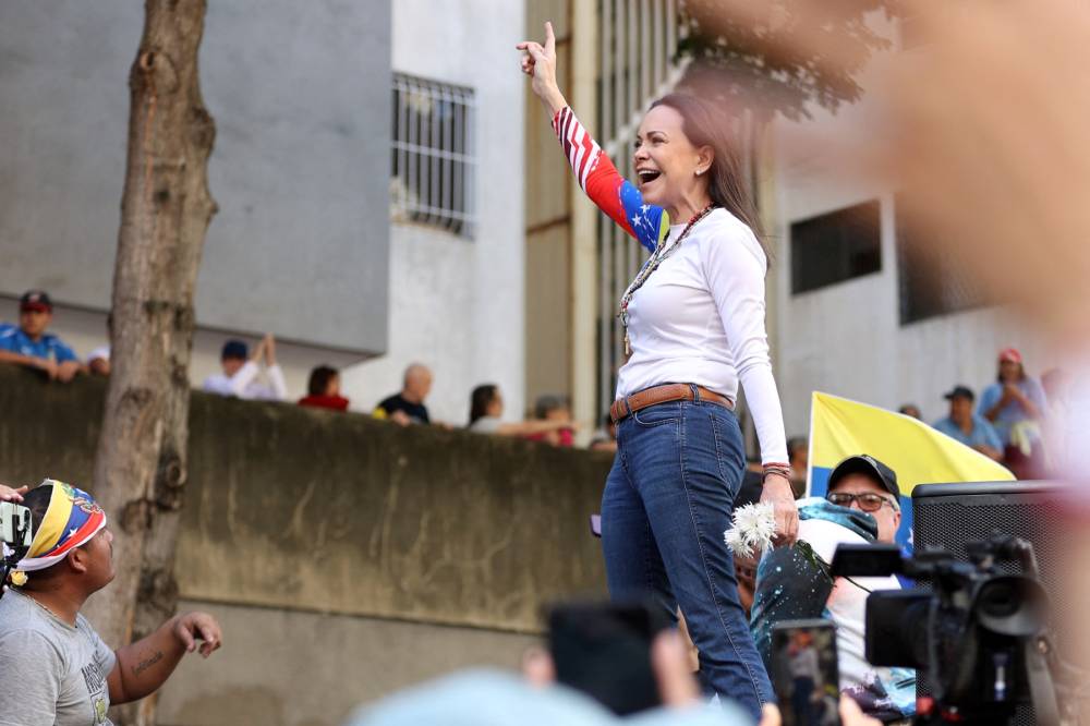Venezuelan opposition leader Maria Corina Machado reacts during a protest called by the opposition on the eve of the presidential inauguration, in Caracas on Jan 9, 2025. - (Photo by PEDRO MATTEY / AFP)