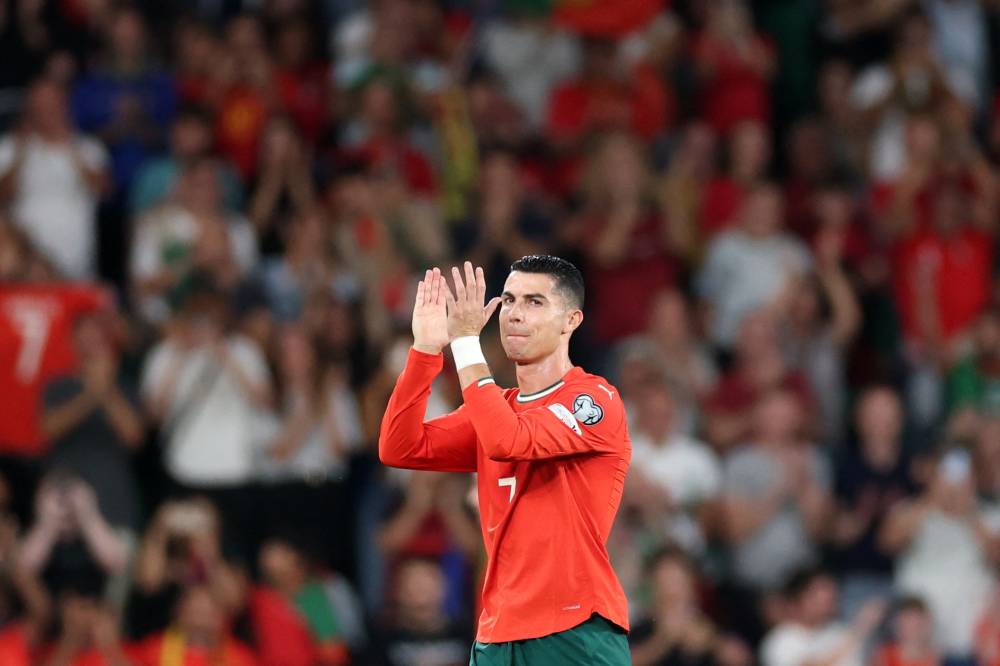 Portugal's forward #07 Cristiano Ronaldo applauds as he leaves the pitch to be substituted during the 2026 World Cup qualifiers Europe zone group F football match between Portugal and Hungary at Jose Alvalade stadium in Lisbon on Oct 14, 2025. - (Photo by PATRICIA DE MELO MOREIRA / AFP)