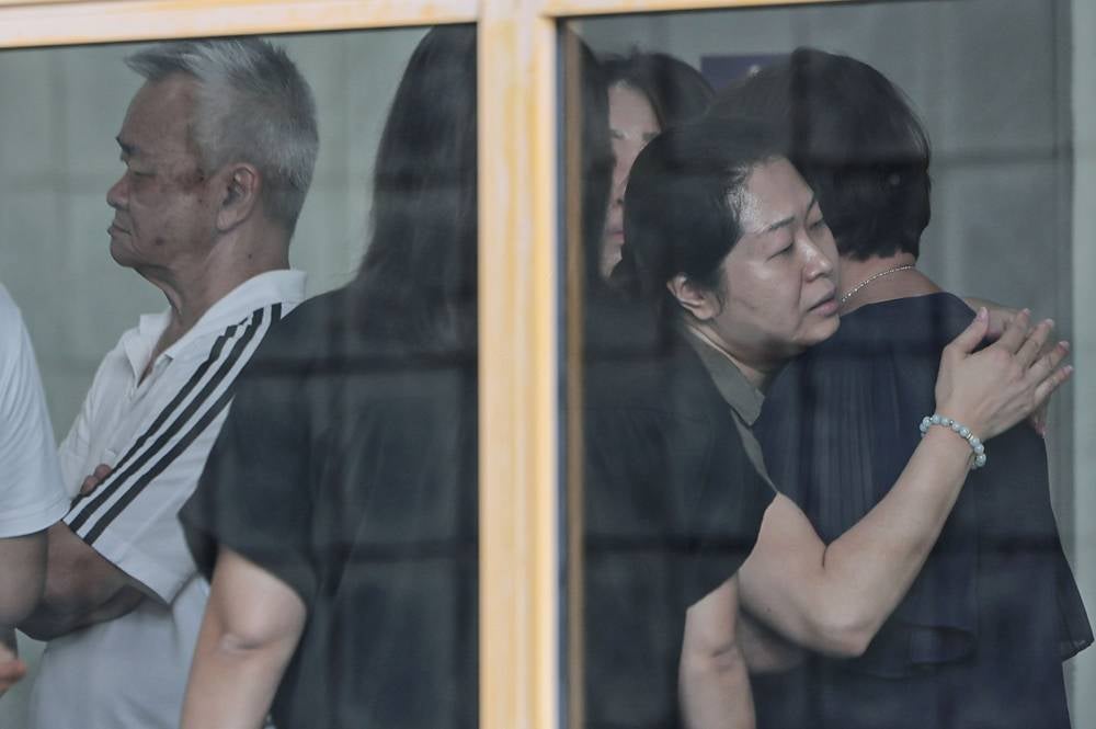 A sombre atmosphere filled the grounds of the Pathology Department at Universiti Malaya Medical Centre as family members of a Form Four student, believed to have been fatally stabbed by a schoolmate in Petaling Jaya, arrived for the post-mortem, yesterday. - Photo by Bernama