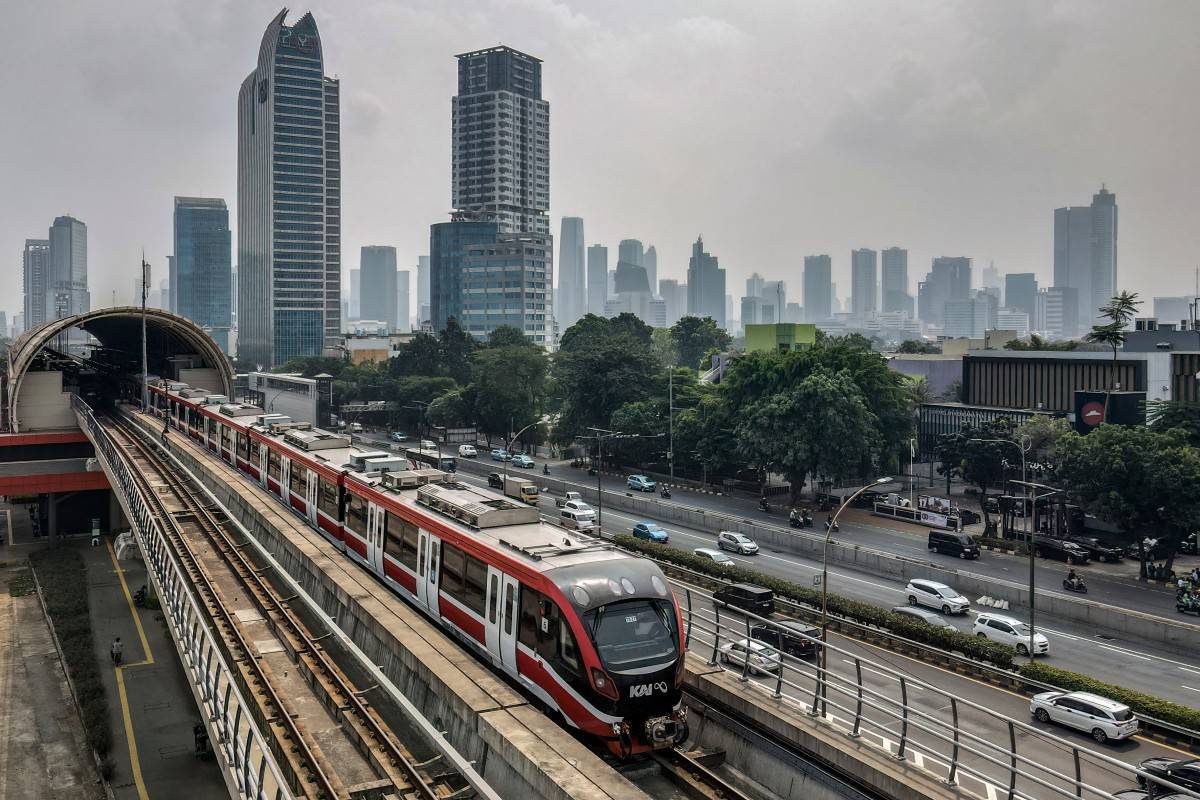 This aerial picture shows a passenger train running on an elevated track in Jakarta’s central business district on August 5, 2025. (Photo by BAY ISMOYO / AFP)
