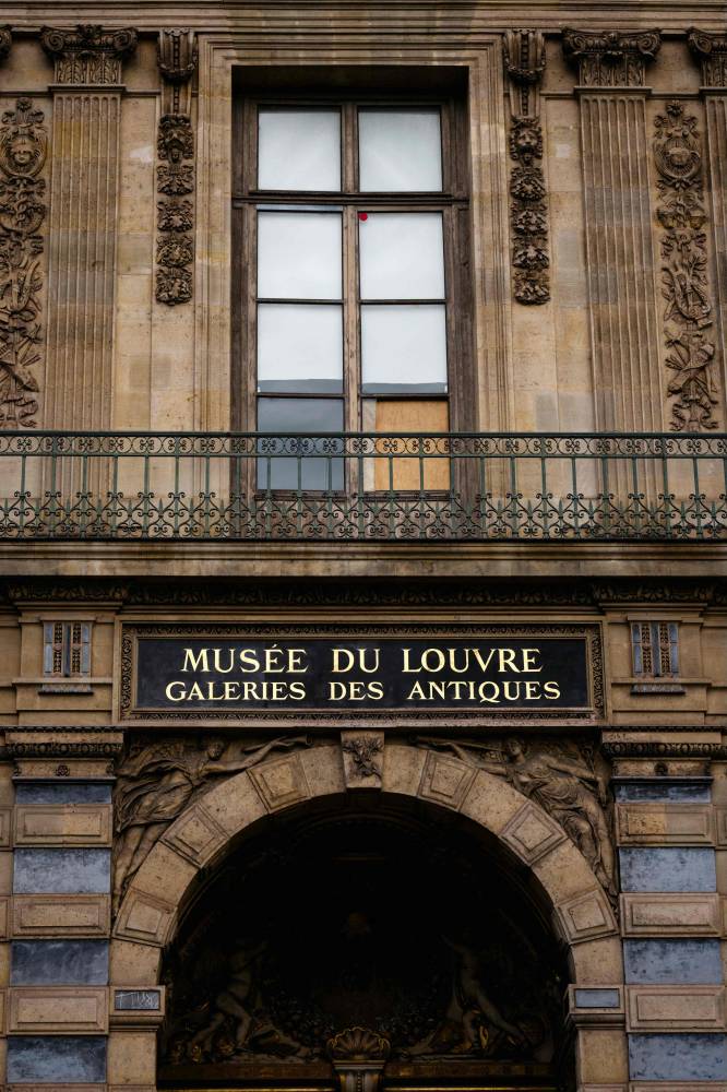 The window of the Louvre Museum is seen with the glasses covered after the thieves broke them to get in and steal priceless jewels. The museum will remain closed for the second day after the theft, in Paris on October 20, 2025. Photo by Dimitar Dilkoff/AFP