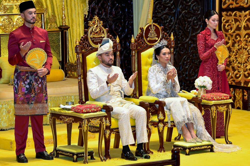 Raja Muda of Selangor Tengku Amir Shah (second left) and his wife Datin Paduka Seri Afzaa Fadiini Abdul Aziz (second right), recite a prayer during the Royal Bersanding Ceremony at the Balairung of Istana Alam Shah, Klang, on Thursday. Photo by Bernama