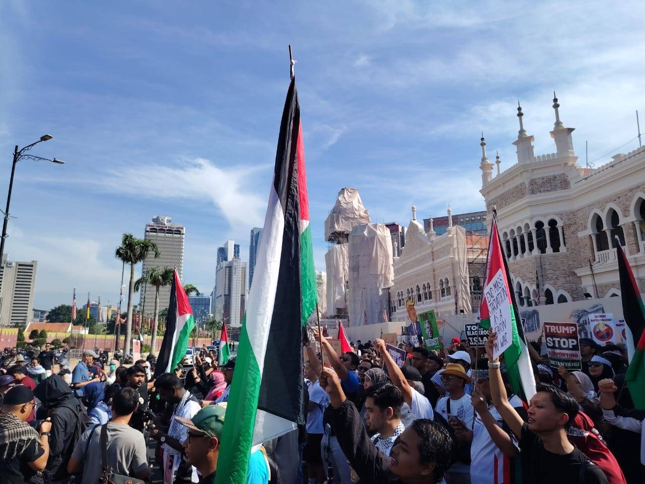 Participants of the Bantah Trump rally gather at Dataran Merdeka, Kuala Lumpur, waving Palestinian flags and holding placards on Sunday. - Photo by Sinar