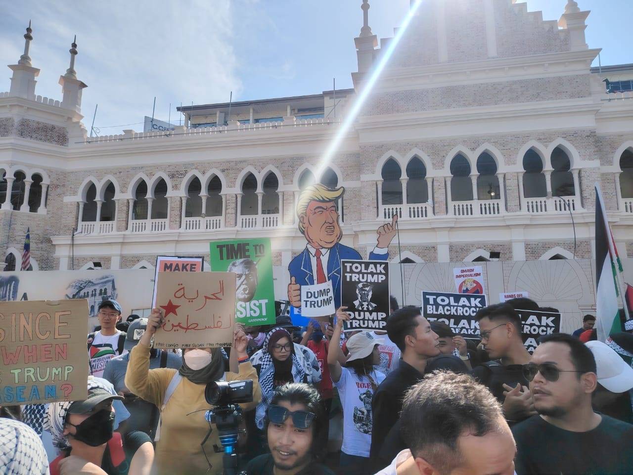 Participants of the Bantah Trump rally gather at Dataran Merdeka, Kuala Lumpur, waving Palestinian flags and holding placards on Sunday. - Photo by Sinar