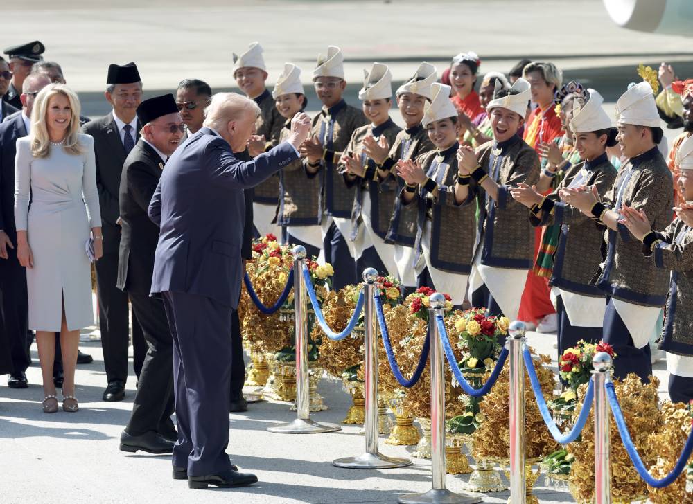 US President Donald Trump arrived in Malaysia yesterday for the 47th Asean Summit, appearing in high spirits as he was warmly welcomed by Prime Minister Datuk Seri Anwar Ibrahim and a lively troupe of traditional Malay dancers dressed in colourful attire. Photo: Bernama