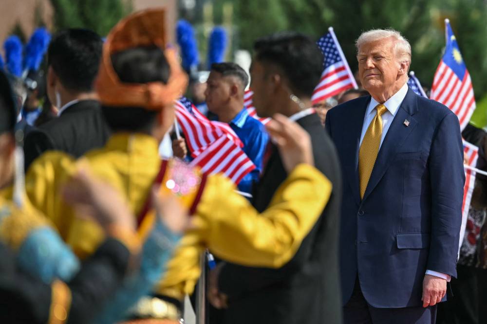 US President Donald Trump looks on before he departs on Air Force One from Kuala Lumpur International Airport in Sepang on October 27, 2025. (Photo by ANDREW CABALLERO-REYNOLDS / AFP)