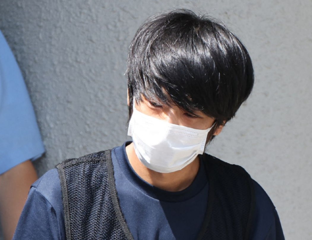 Tetsuya Yamagami, the man accused of murdering former Japanese Prime Minister Shinzo Abe, is transferred from the Nara Nishi police station for psychiatric examination in Nara on July 25, 2022. - (Photo by JIJI PRESS / AFP)