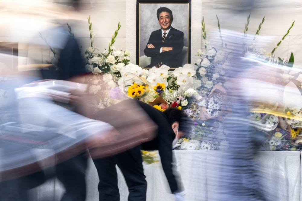 People pay their respects during a memorial service on the first death anniversary of Japan's former prime minister Shinzo Abe, at Zojoji Temple in Tokyo on July 8, 2023. - (Photo by PHILIP FONG / AFP)