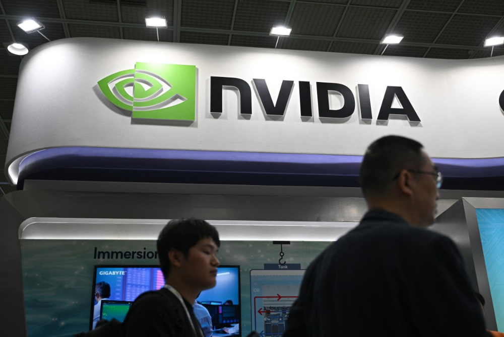 Visitors walk past the logo of NVIDIA during the Korea Electronics Show 2025 at the COEX convention and exhibition centre in Seoul on October 22, 2025. (Photo by Jung Yeon-je / AFP)