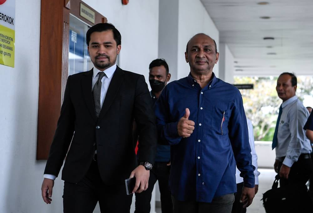 Political activist Zamil Ibrahim, 58, (second, right) and two others pleaded not guilty in the Sessions Court today, to a charge of soliciting and accepting bribes from a celebrity preacher last year. Photo by Bernama.