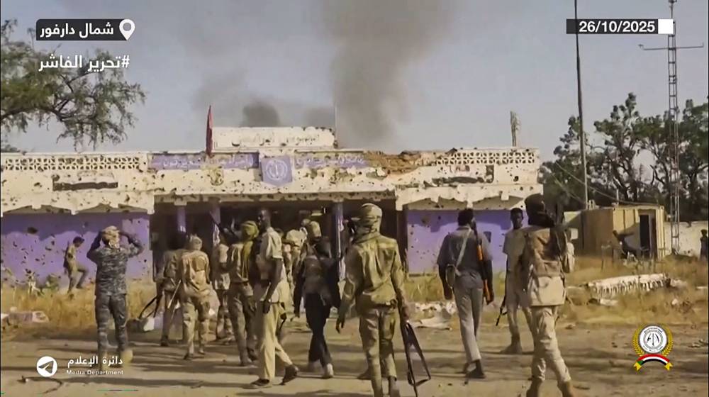 This image grab taken from handout video footage released on Sudan's paramilitary RSF Telegram account on Oct 26, 2025, shows RSF fighters holding weapons and celebrating in the streets of El-Fasher in Sudan's Darfur. - (Photo by Rapid Support Forces (RSF) / AFP)