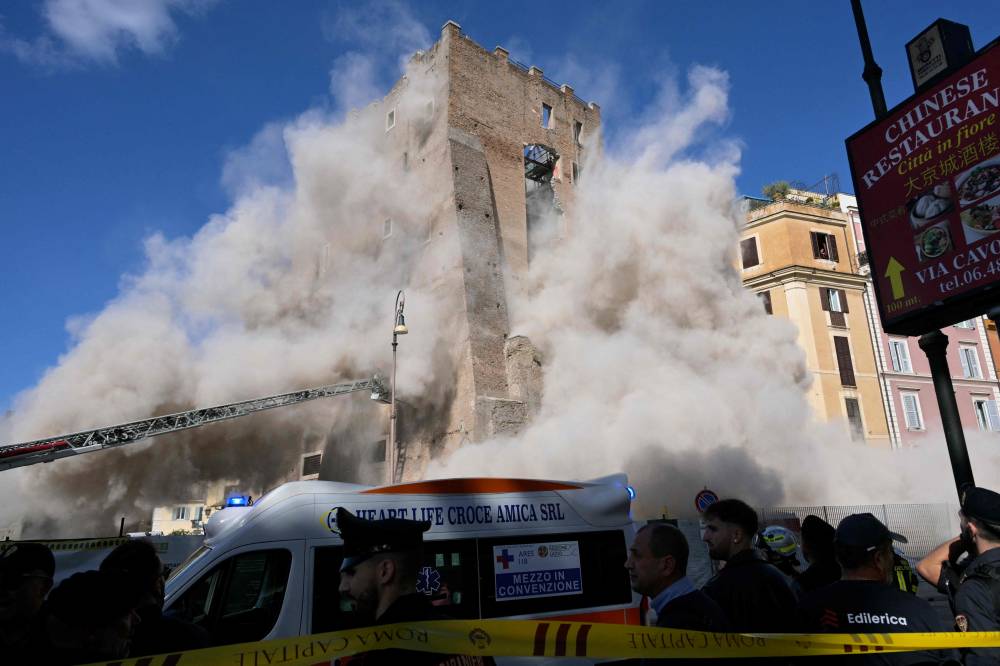 Dust rises due to a second collapse of part of the medieval tower "Torre dei Conti" near the Roman Forum in the historic center of Rome on Nov 3. Photo by Tiziana Fabi/AFP