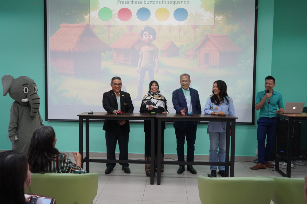 An elephant mascot is presented to commemorate the launch of the Management and Ecology of Malaysian Elephants (MEME) online. course. -Photo: Management & Ecology of Malaysian Elephants (MEME) 