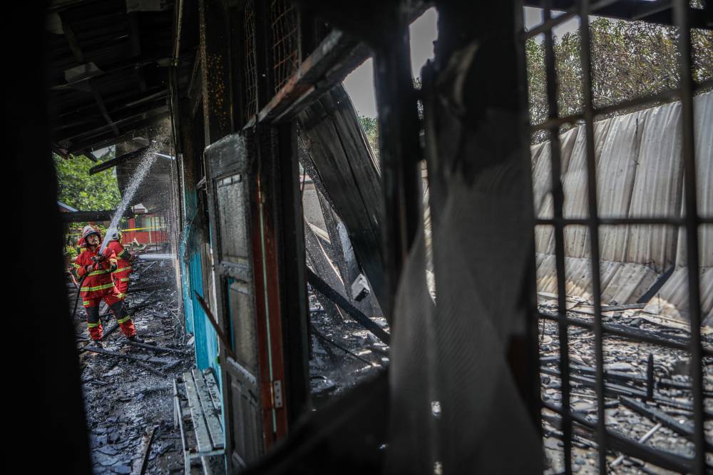 An eight-room building at Sekolah Kebangsaan (SK) Padang Melangit near here was about 90 per cent destroyed in a fire that occurred this morning, also causing a private cleaning worker to sustain 30 per cent burns. Photo by Bernama