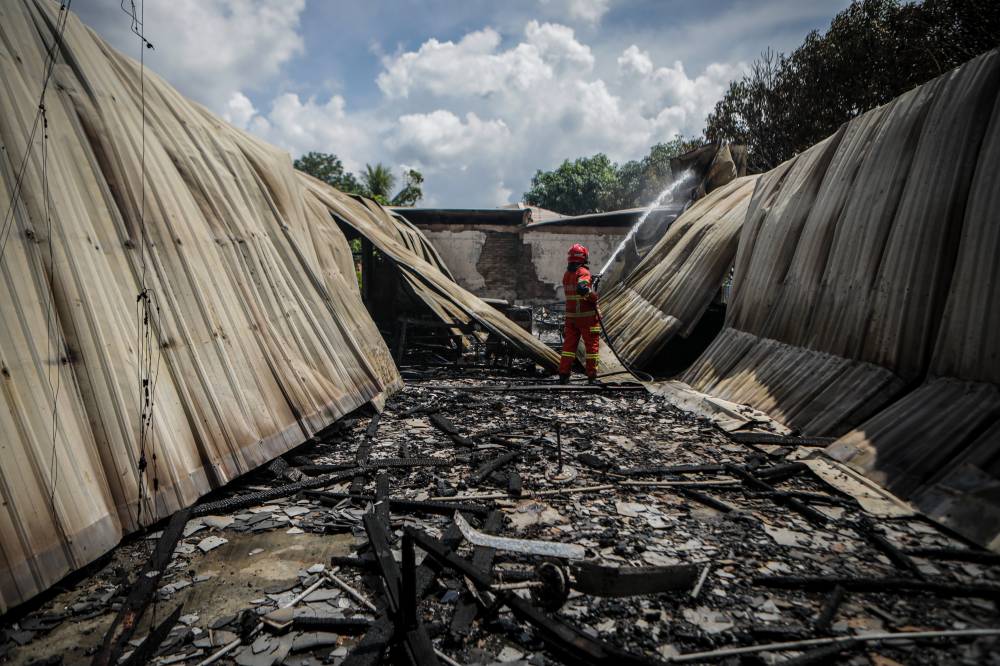 An eight-room building at Sekolah Kebangsaan (SK) Padang Melangit near here was about 90 per cent destroyed in a fire that occurred this morning, also causing a private cleaning worker to sustain 30 per cent burns. Photo by Bernama