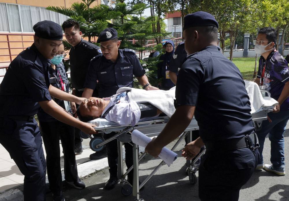 PKS candidate for the Kiulu State Legislative Assembly Dusi Gingging had to be rushed to Tuaran Hospital for further treatment during the nomination process for the 17th Sabah state election at Dewan Seri Sulaman today. - Photo by Bernama