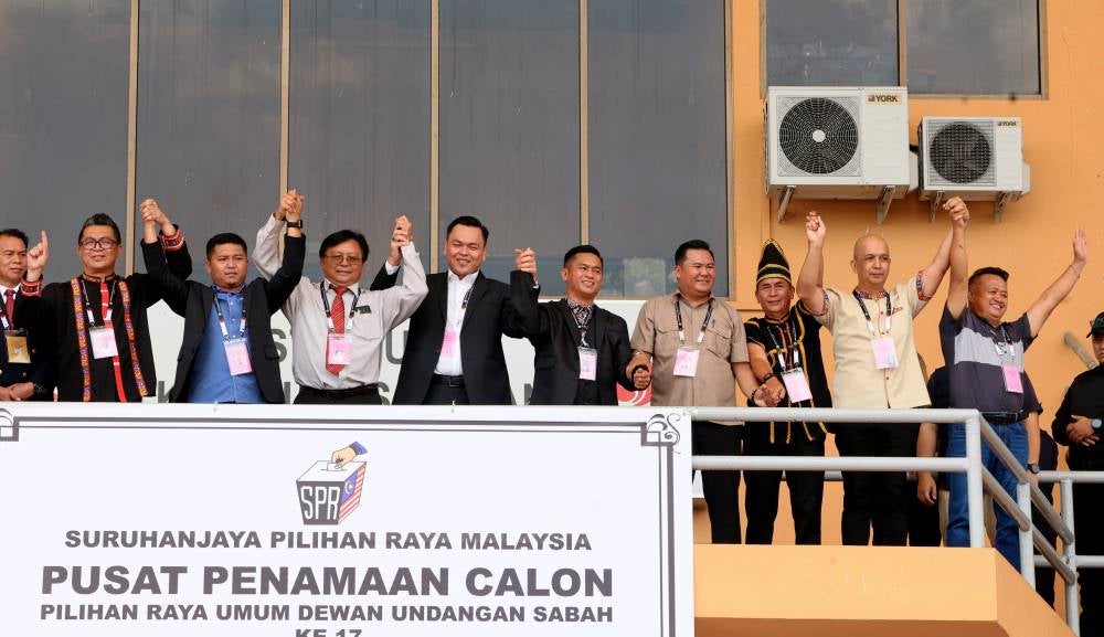 Gabungan Rakyat Sabah (GRS) candidate for the Bingkor State Legislative Assembly, Rafie Robert (fourth, left) faces stiff competition when Elections Officer Peter Jonu @Peter announced 10 candidates contesting for the Liawan DUN. Photo by Bernama