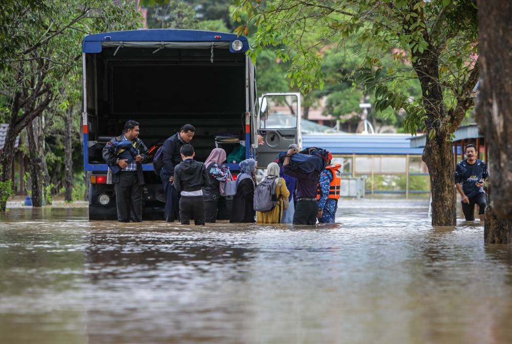 SPM examination staff transported exam papers by lorry after the school was flooded during an inspection at SMK Syed Hussein, Arau on Nov 25, 2025. - Photo by Bernama