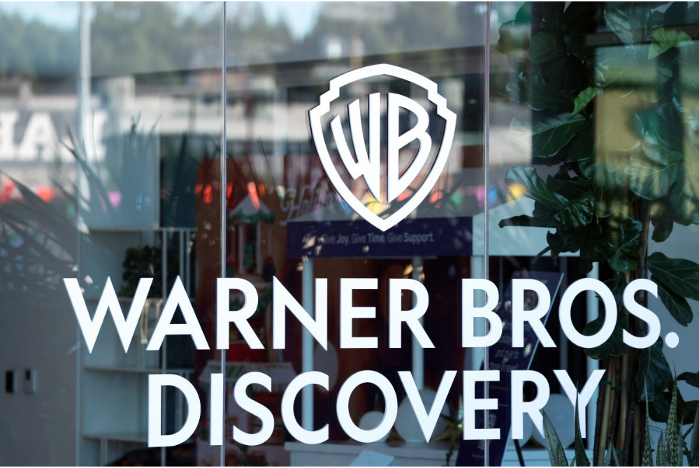 The logo of Warner Bros. Discovery is seen at one of their offices in Culver City, California, on Dec 5. Streaming giant Netflix said Dec 5, it will buy film and television studio Warner Bros. Discovery for nearly $83 billion, the entertainment industry's biggest consolidation deal this decade. The acquisition gives Netflix access to a vast film catalog as well as the prestigious streaming service HBO Max. - Photo by Patrick T. Fallon / AFP