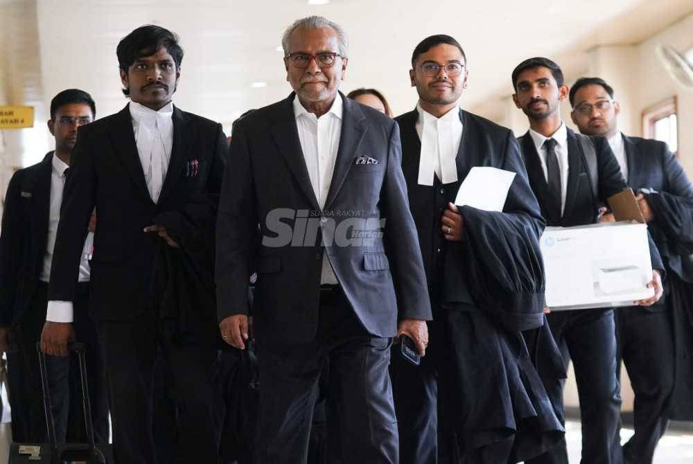 Tan Sri Muhammad Shafee Abdullah (front) and the defence team at the Kuala Lumpur High Court on Monday.

