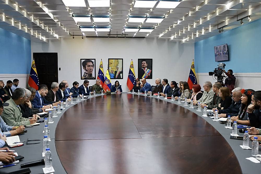This handout picture released by the Miraflores Palace press office shows Venezuela's Vice-President Delcy Rodriguez (C) speaking next to Venezuelan Defense Minister Vladimir Padrino Lopez (C-L) and Venezuela's Minister of Interior Relations, Justice, and Peace, Diosdado Cabello (C-R) during a council of ministers meeting at the Vice Presidency headquarters in Caracas on Jan 4, 2026. President Donald Trump insisted on Jan 4, 2026, that the United States is "in charge" of Venezuela after the seizure of Nicolas Maduro, but was also dealing with the new interim leadership in Caracas. - (Photo by Marcelo Garcia / Miraflores press office / AFP)