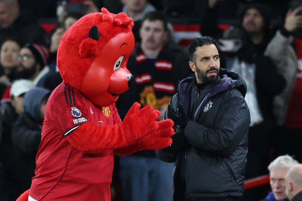 Manchester United's Portuguese head coach Ruben Amorim (R) ahead of kick-off in during the English Premier League football match between Manchester United and Everton at Old Trafford in Manchester, north west England, on November 24, 2025. (Photo by Darren Staples/AFP)