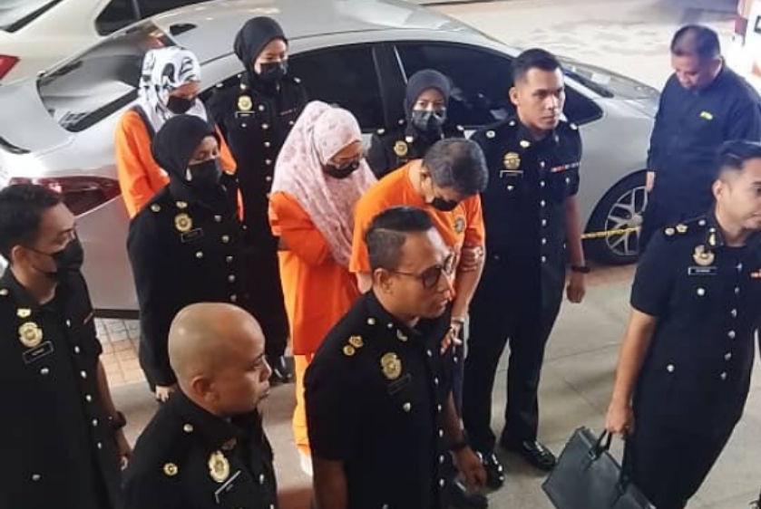 A former Malaysian army chief and his two wives arrived at the Putrajaya magistrate's court on Thursday for remand proceedings to assist investigations into a corruption case involving an alleged procurement tender cartel linked to the Malaysian Army.