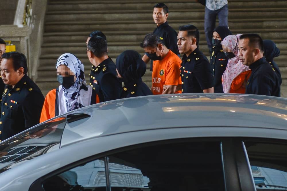 The three suspects were brought to court at about 10 am after being detained at the MACC headquarters yesterday evening. - Bernama photo