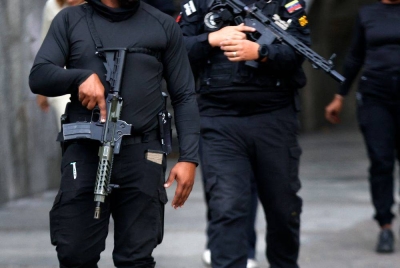 Members of the National Direction of Military Counterintelligence of Venezuela, walk near the Miraflores presidential palace in Caracas on Jan 3, 2026, after US forces captured Venezuela's President Nicolas Maduro. - (Photo by PEDRO MATTEY / AFP)