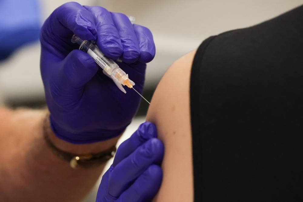A pharmacist administers the Pfizer-BioNTech Covid-19 vaccine to an attendee of an immunisation event at the L.A. Care and Blue Shield of California Promise Health Plan Community Resource Center in the Panorama City neighborhood of Los Angeles, California, on Oct 24, 2025. - (Photo by Patrick T. Fallon / AFP)