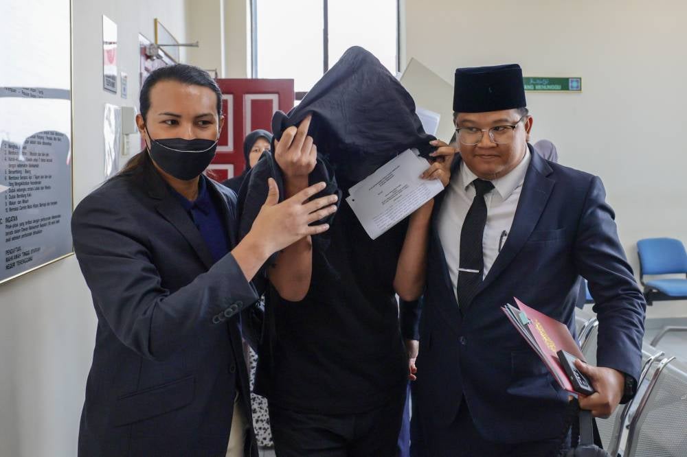 Mohd Lukman Mohamad Aluddin, 33, pleaded not guilty today at the Syariah High Court here to charges of cross-dressing and behaving like a woman last year. Photo by Bernama