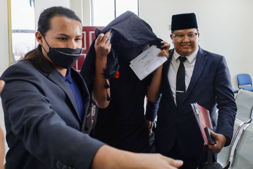 Mohd Lukman Mohamad Aluddin, 33, pleaded not guilty today at the Syariah High Court here to charges of cross-dressing and behaving like a woman last year. Photo by Bernama