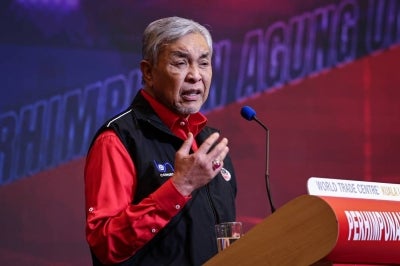 Umno President Datuk Seri Ahmad Zahid Hamidi delivers his speech at the Political Symposium in the Digital Era 2026 on the first day of the 2025 Umno General Assembly, which runs from Jan 14 to 17, at the Kuala Lumpur World Trade Centre (WTCKL) today. Photo by Bernama