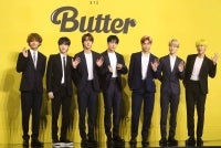 Members of South Korean K-pop boy band BTS pose for photographs during a press conference to promote their new single album 'Butter' in Seoul on May 21, 2021. - (Photo by Dong-A Ilbo / AFP)