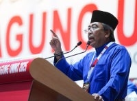 Johari Abdul Ghani during his winding-up speech during the 2025 Umno General Assembly. (Photo by Rosli Talib) 