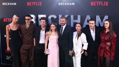 Former England footballer David Beckham (5L) and his wife Victoria Beckham (3R) pose on the red carpet with their children and partners, (from L) Mia Regan, Romeo Beckham, Cruz Beckham, Harper Beckham, Brooklyn Beckham Nicola Peltz Beckham upon arrival to attend the Premiere of "Beckham" in London on Oct 3, 2023. - (Photo by HENRY NICHOLLS / AFP)