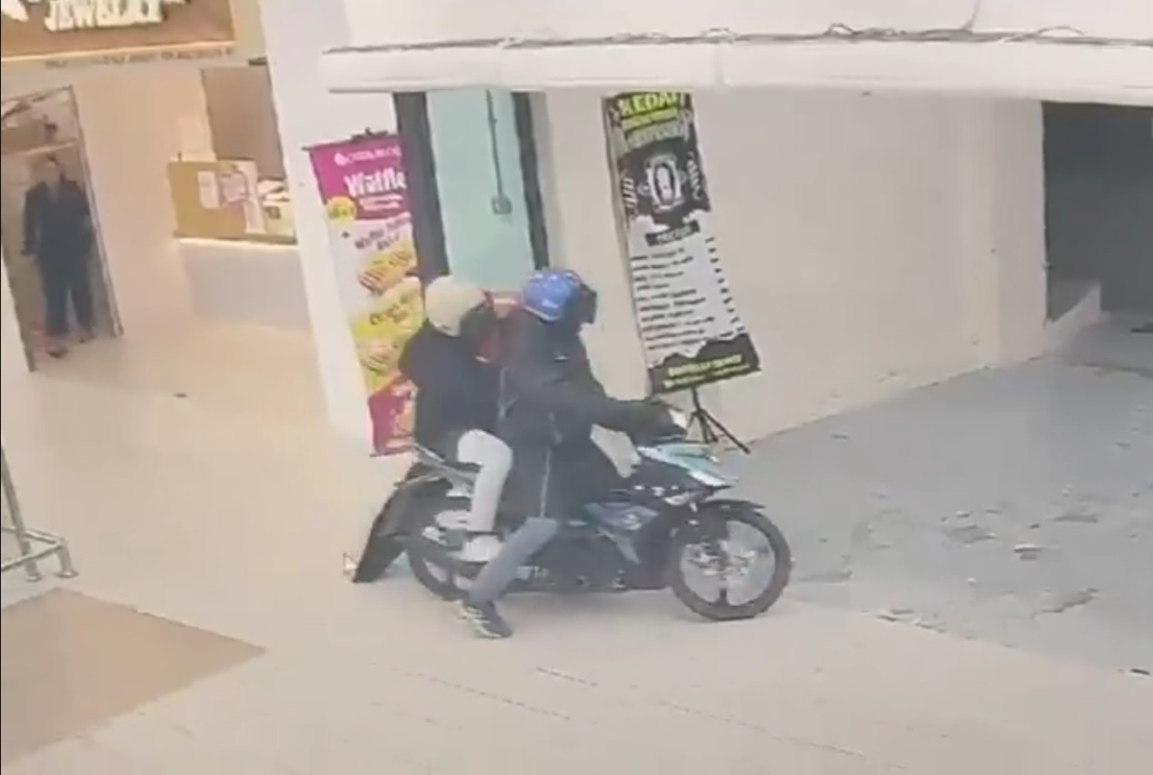 Police are hunting two local men suspected of being involved in an armed robbery at a gold shop inside a shopping mall in Bandar Baru Nilai here last night. Photo: Screenshot of CCTV recording.