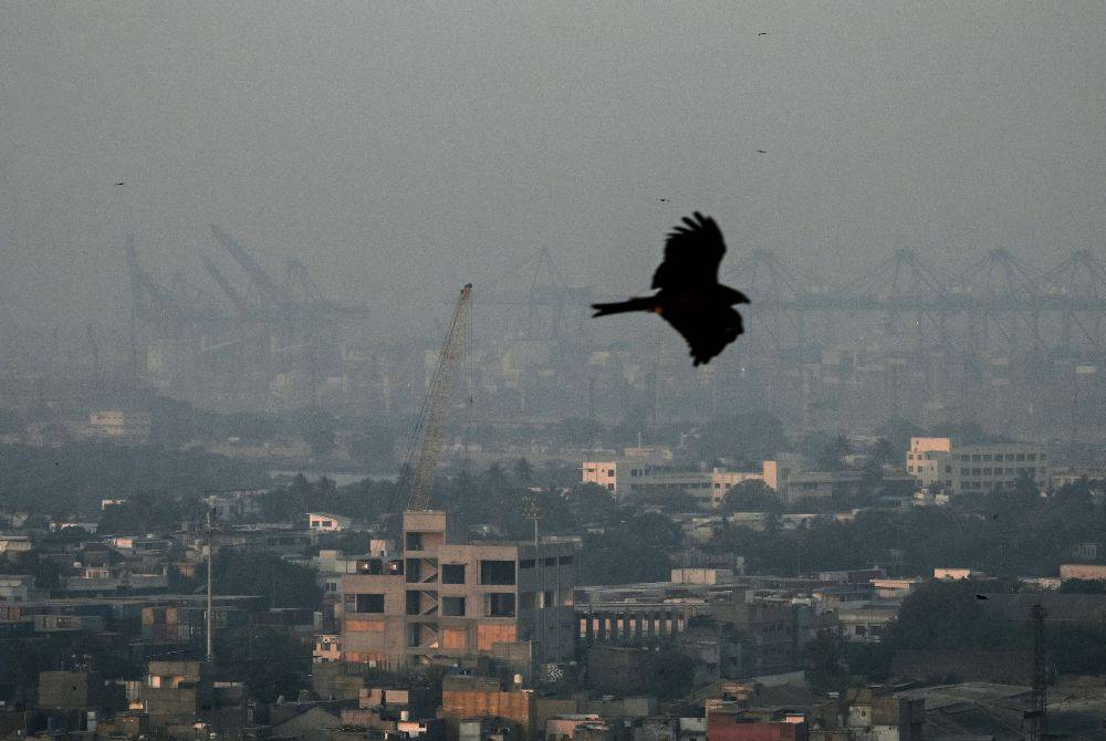 This photograph taken on Jan 10, 2026 shows a kite flying over the city amid dense smog in Karachi. - (Photo by ASIF HASSAN / AFP)
