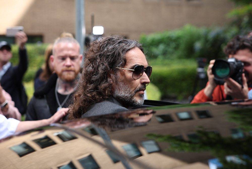 British comedian and actor Russell Brand leaves following a hearing at Southwark Crown Court in south London on May 30, 2025. - (Photo by HENRY NICHOLLS / AFP)