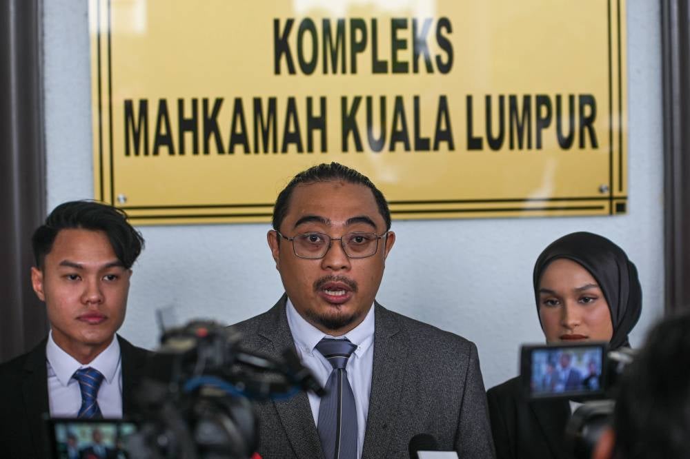 Lawyer Muhamad Firdaus Jumaludin (centre), who represents senior Malaysian Armed Forces (ATM) officer Vice Admiral Datuk Sabri Zali, speaks to reporters at a press conference at the Kuala Lumpur Court Complex Jan 21. - Bernama photo