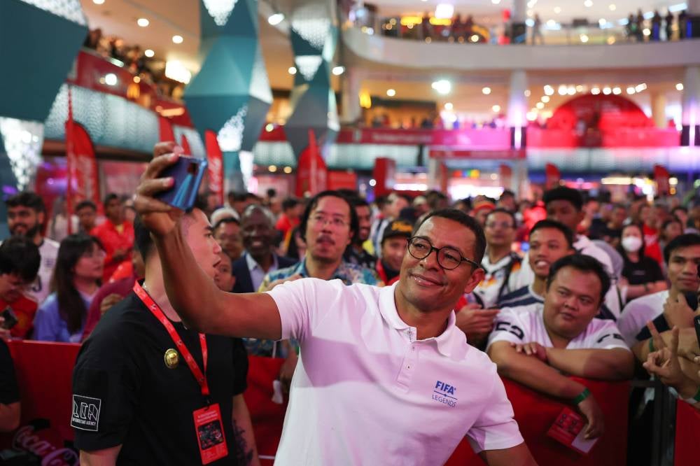 Brazilian World Cup legend Gilberto Silva takes a selfie with fans after accompanying the FIFA World Cup Trophy to Malaysia as part of the 75-country Global Tour in conjunction with the 2026 World Cup today. - Bernama photo