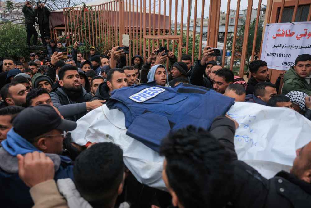 Palestinian family members and colleagues carry the bodies of Palestinian journalists killed in an Israeli strike, as they leave the Nasser Hospital for burial, in Khan Yunis in the southern Gaza Strip on January 21, 2026. (Photo by Bashar Taleb / AFP)