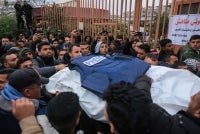 Palestinian family members and colleagues carry the bodies of Palestinian journalists killed in an Israeli strike, as they leave the Nasser Hospital for burial, in Khan Yunis in the southern Gaza Strip on January 21, 2026. (Photo by Bashar Taleb / AFP)