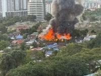Three squatter houses were completely destroyed in a fire this morning at Jalan Kwangyi, Kampung Bellamy, near the Nirvana Cemetery grounds here. Photo: Social media
