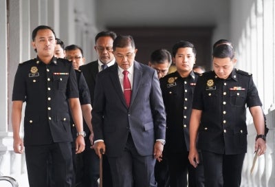 Former Armed Forces Chief Tan Sri Mohd Nizam Jaafar arrives at the Sessions Court this morning to face four charges, including abuse of power and criminal breach of trust. Photo by Rosli Talib