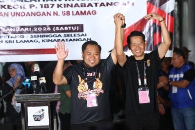 The incumbent Kinabatangan Member of Parliament Mohd Kurniawan Naim Moktar and the candidate for Lamag State Legislative Assembly (DUN) Mohd Ismail Ayob, better known as Miha, celebrate their victories after being announced as winners of their respective seats at the Official Vote Tallying Centre for the by-elections at Dewan Sri Lamag. Photo by Bernama