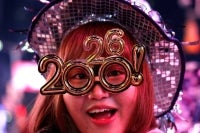 A reveler poses as she celebrates New Year's Eve in Times Square on Dec 31, 2025 in New York. (Photo by John Lamparski / AFP)